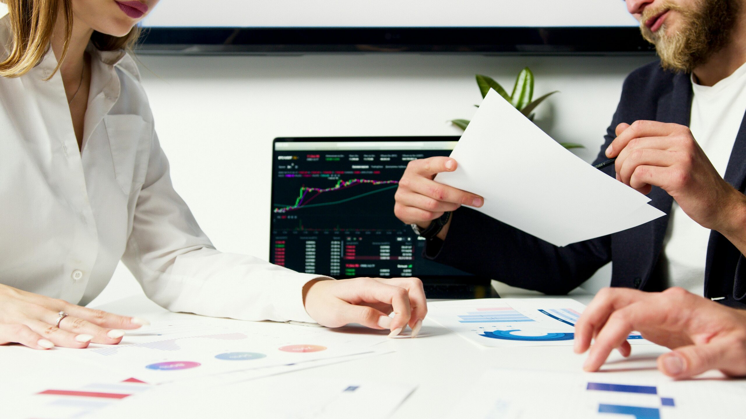 Marketing professionals analyzing campaign performance data and optimization strategies on digital dashboards.