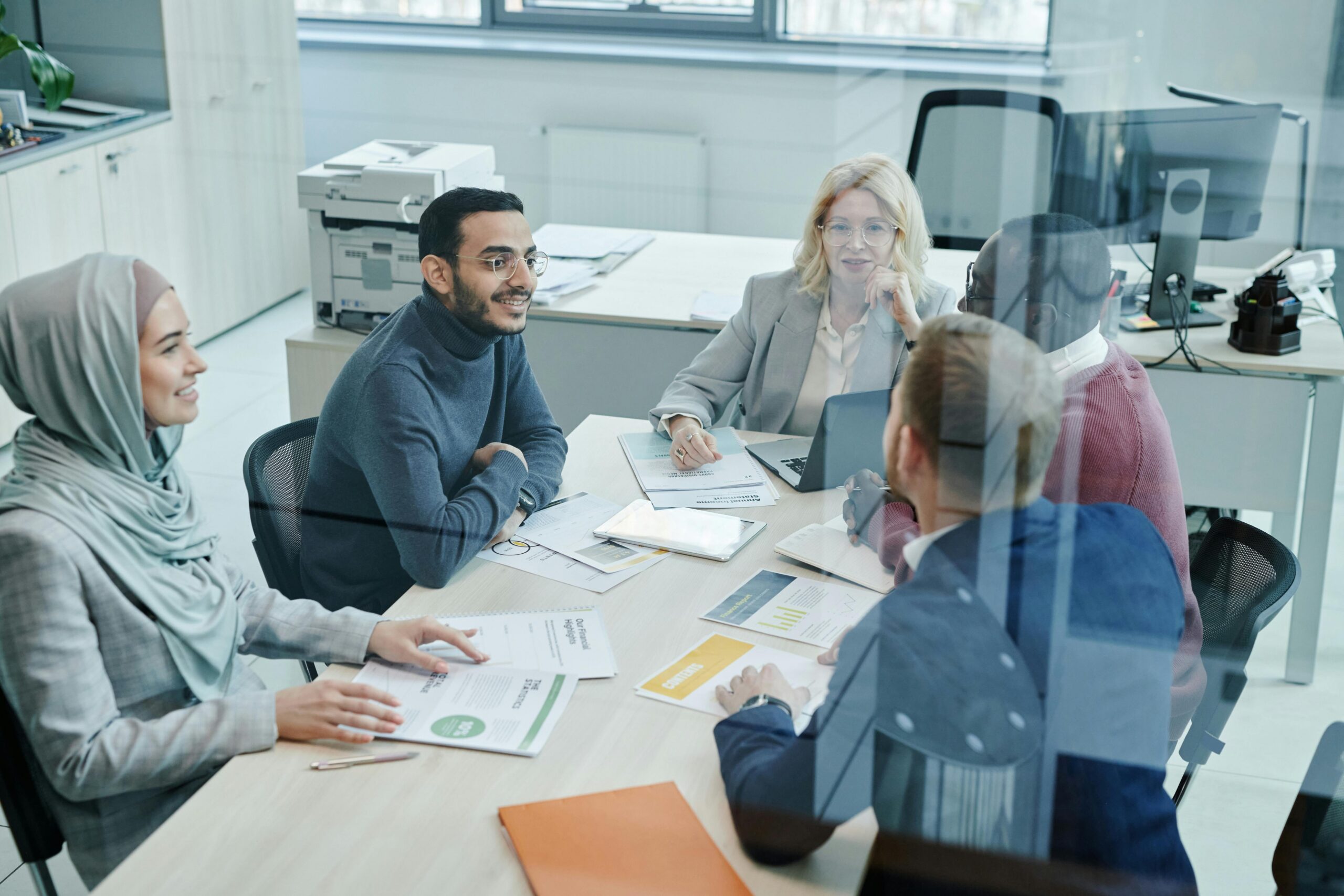 Direct marketing professionals discussing customer outreach strategies during a team meeting